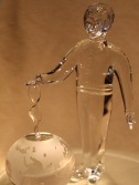 glass figurine of boy with healing force toward globe